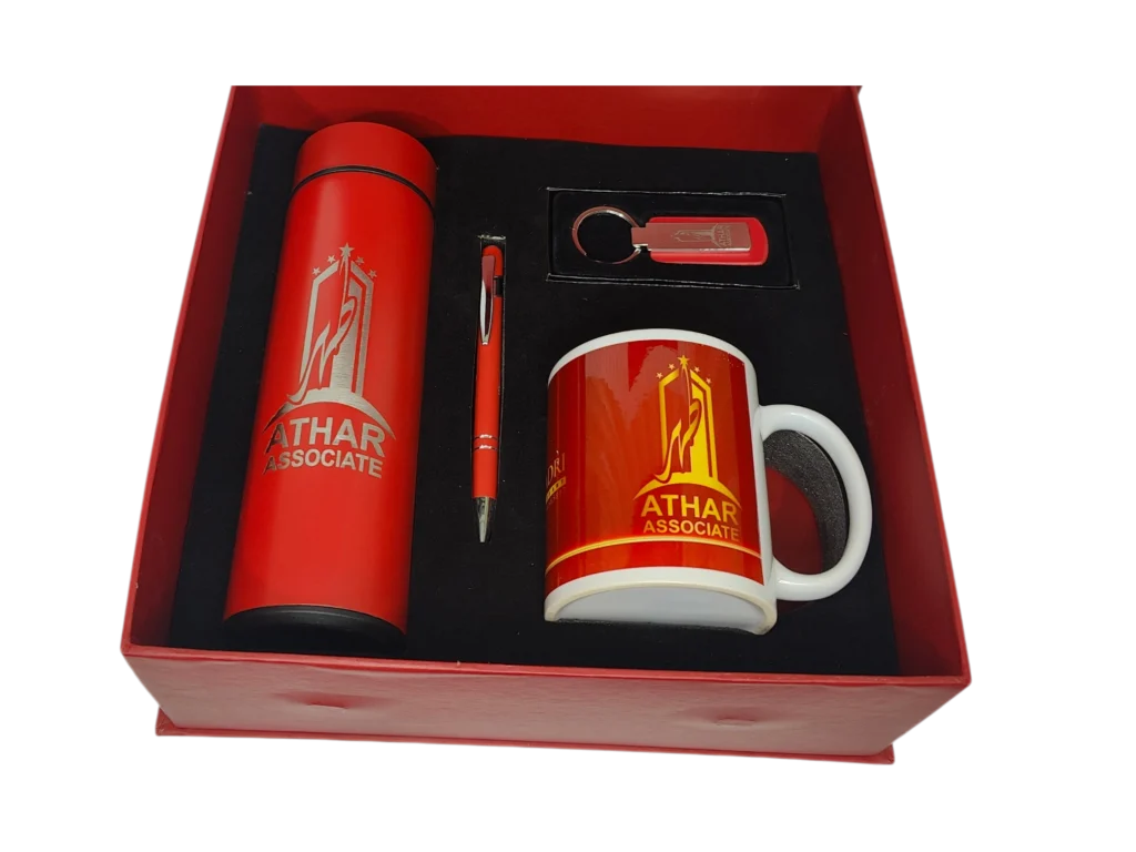 Athar Associate custom red corporate gift set including a branded thermal bottle, ceramic mug, pen, and keychain.