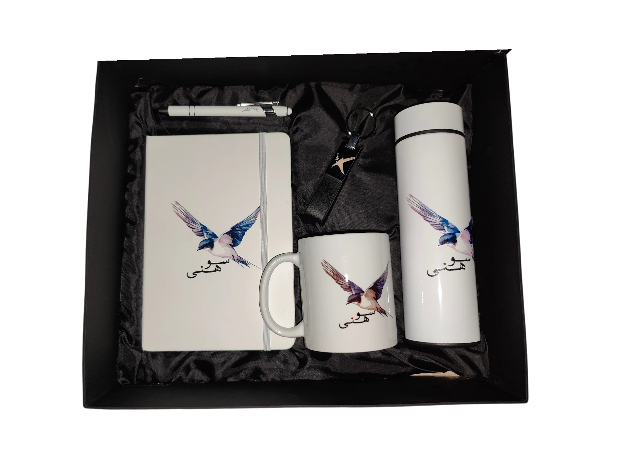 Premium white corporate gift set featuring a notebook, mug, bottle, pen, and keychain with custom illustration.
