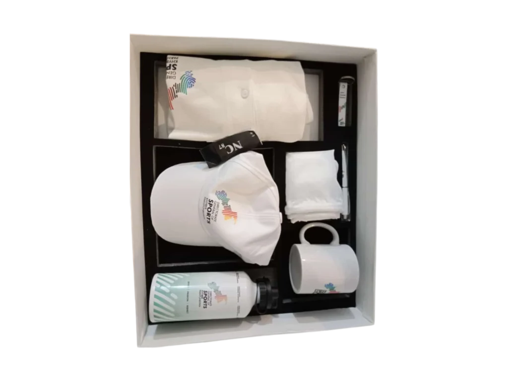 Sports-themed corporate kit featuring a branded polo shirt, cap, mug, water bottle, and accessories in a white gift box.