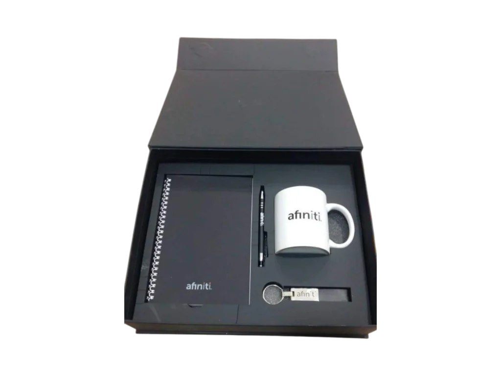 Black and white corporate gift set with spiral notebook, white mug, pen and keychain