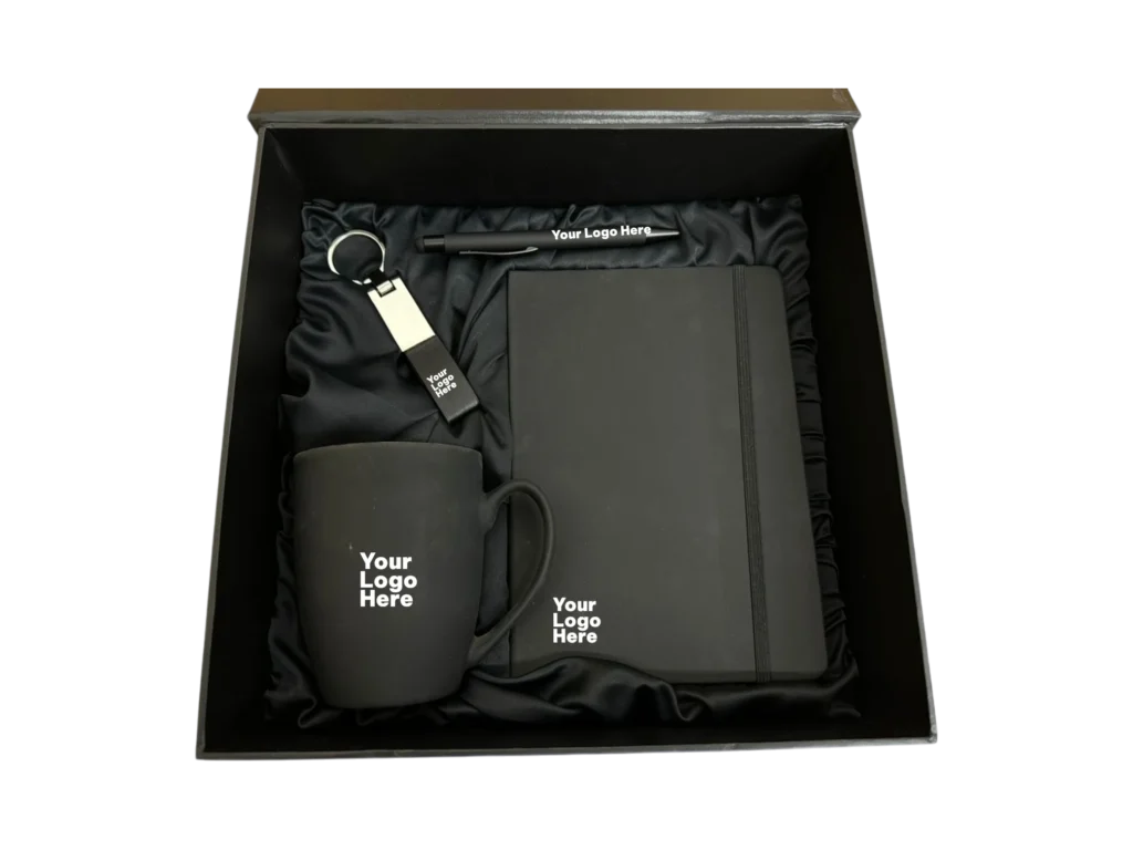 All black corporate gift set with mug, notebook, pen and keychain in black satin box