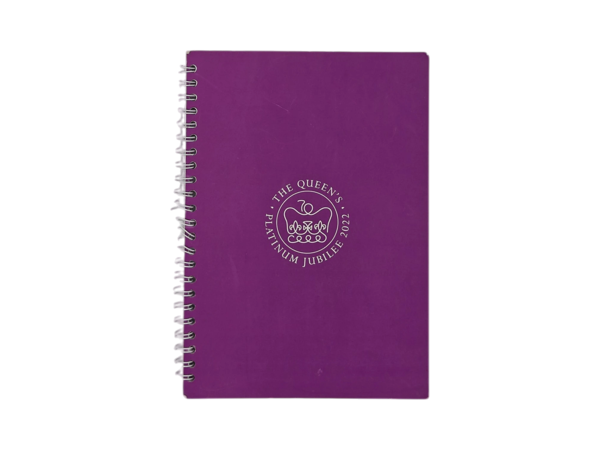Custom royal purple spiral notebook with embossed commemorative seal for corporate gifting.