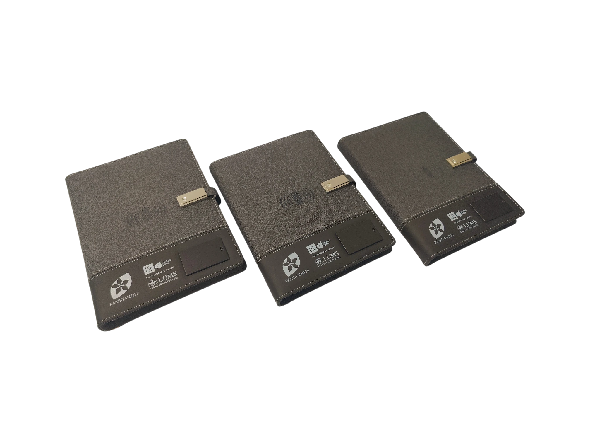 Interior of smart notebook power bank showing 8000mAh battery, USB drive, wireless charger and dual charging cables for corporate gifting